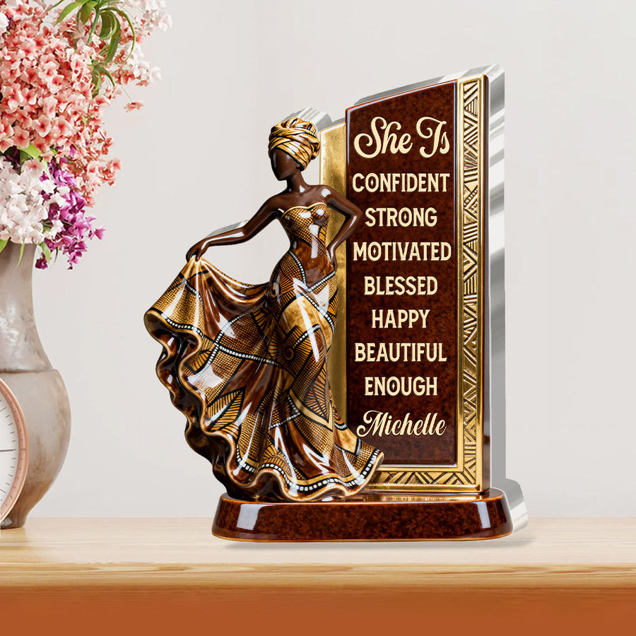 Hands holding the personalized plaque in front of a bookshelf