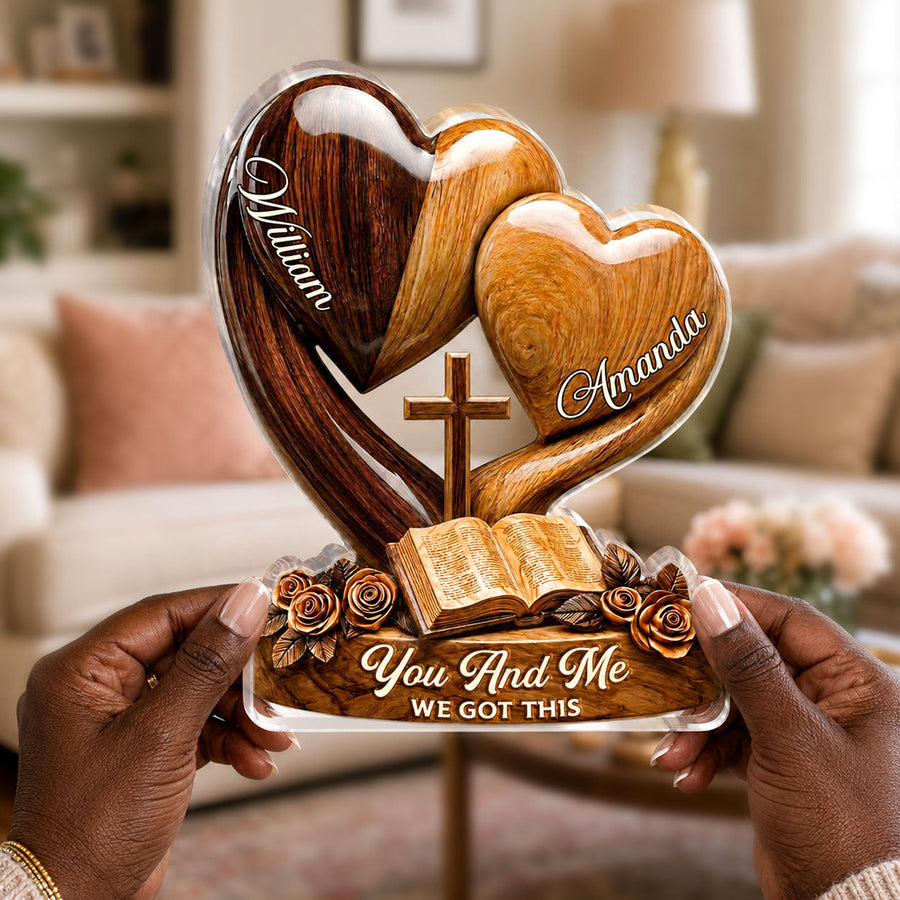 Hands holding the personalized plaque in front of a bookshelf