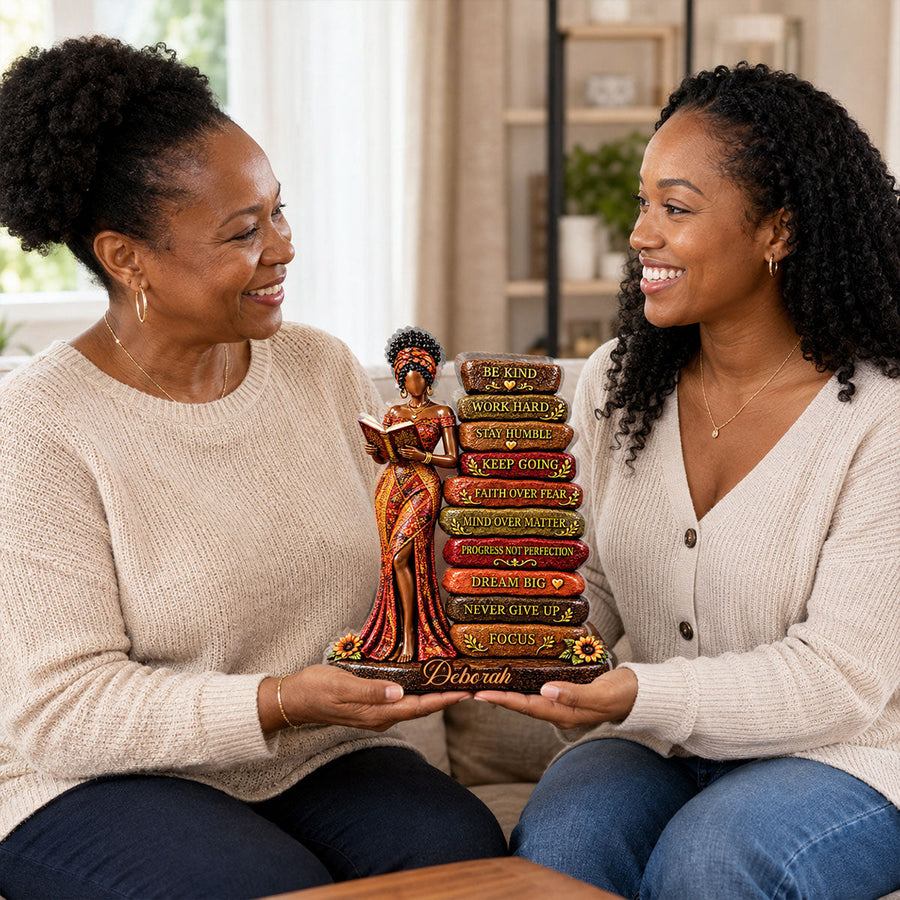 Hands holding the personalized plaque in front of a bookshelf