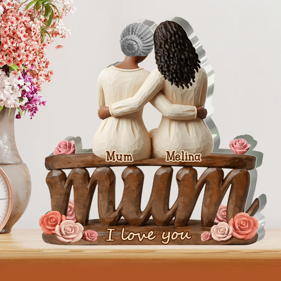 Hands holding the personalized plaque in front of a bookshelf