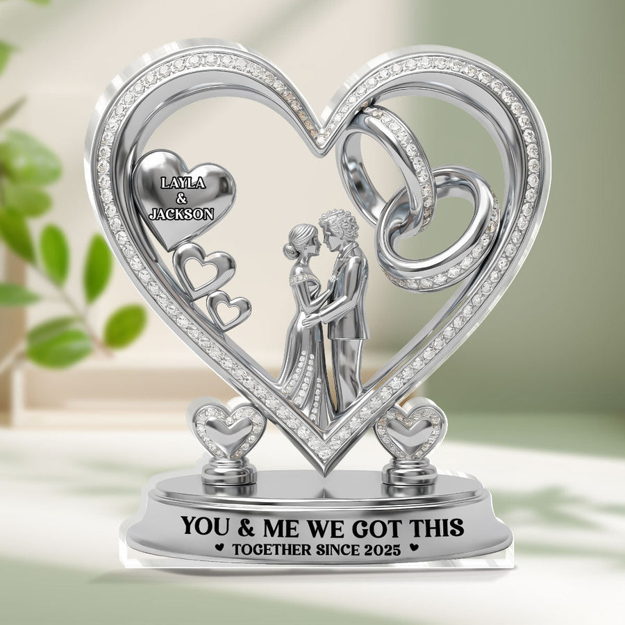 Hands holding the personalized plaque in front of a bookshelf