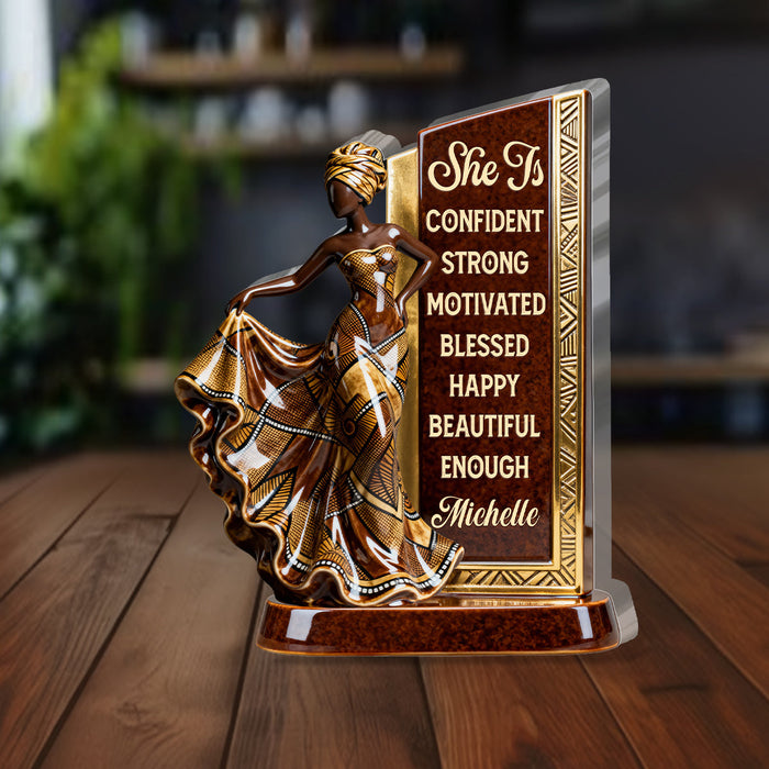 Woman smiling while holding her personalized plaque
